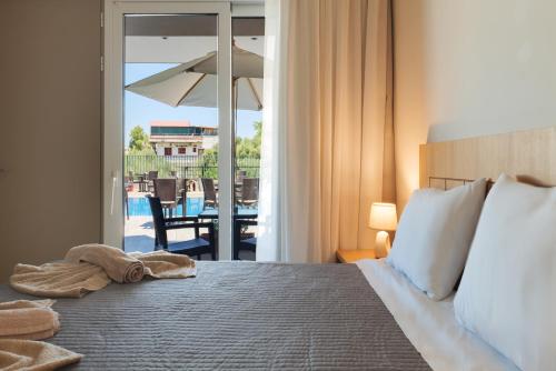 a bedroom with a bed with a view of a patio at Jechrina in Kato Daratso