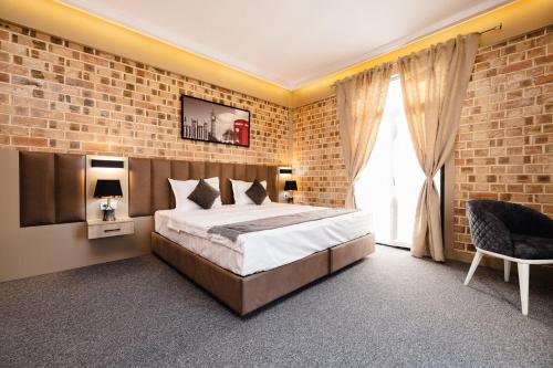 a bedroom with a bed and a brick wall at Air Solief in Tashkent