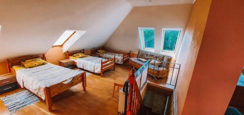 a living room with two beds and a couch at Šubrakkrasti in Vestiena