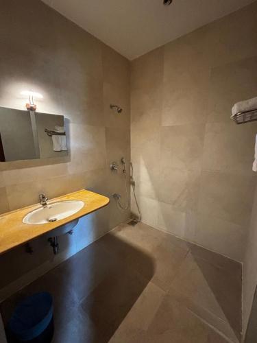 a bathroom with a sink and a shower at The Yellow Retreat in Wai