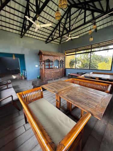 a large room with a wooden table and benches at The Yellow Retreat in Wai