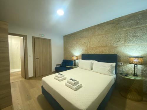 a bedroom with a large bed with towels on it at Raianos in Tui