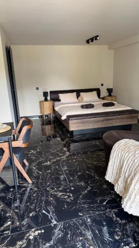 a bedroom with a bed and a table and chairs at My Wellness Ferienwohnung in Bullay