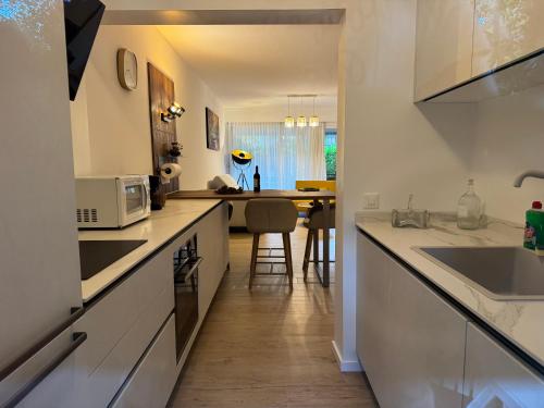 a kitchen with white cabinets and a counter top at Ikigai Ascona in Ascona