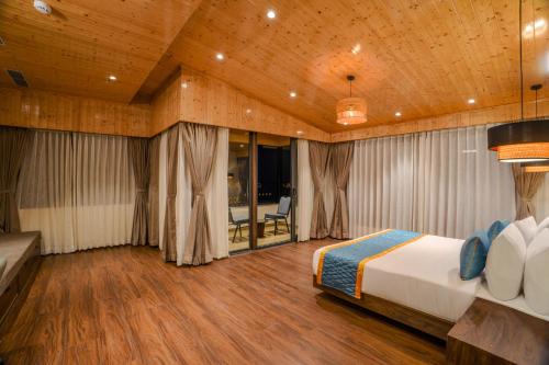 a bedroom with a bed in a room with wooden ceilings at Zone by The Park Darjeeling in Darjeeling