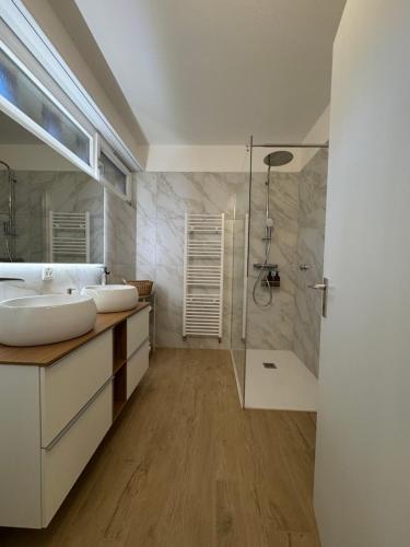 a bathroom with two sinks and a shower at Ikigai Ascona in Ascona