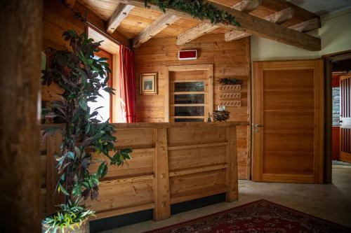 a wooden room with a door and a wine cellar at Hotel Funivia in Chiesa in Valmalenco