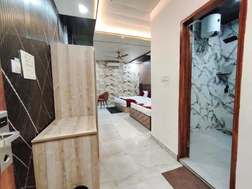 a corridor of a hotel room with a bedroom at Hotel Ganga Pearl in Rishīkesh