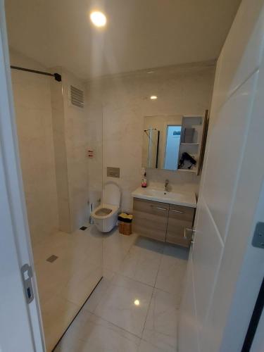 a bathroom with a toilet and a sink and a mirror at miamia apart otel in Trabzon