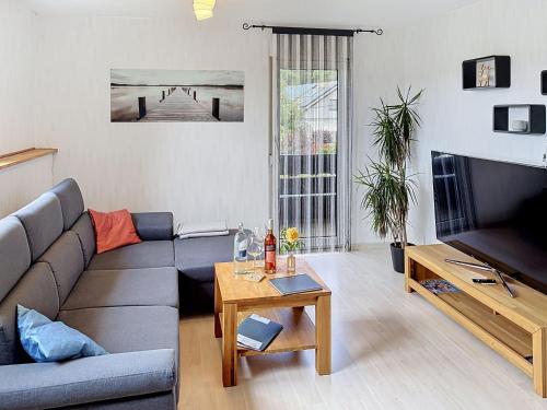 a living room with a couch and a table at Apartment Blackforest Birdnest by Interhome in Schonach
