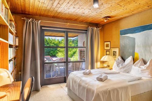a bedroom with a bed and a large window at Villa Mona Lisa in Seefeld in Tirol