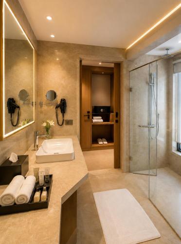 a bathroom with a sink and a shower at The Crown Puducherry in Pondicherry