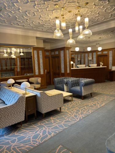 a lobby with couches and tables and a salon at The Newgrange Hotel in Navan
