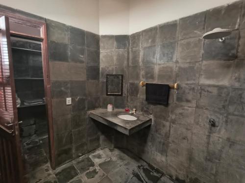 a bathroom with a sink and a shower at Pousada Casa Atlântica in Luis Correia