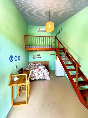 a bedroom with a bunk bed and a staircase at Loft Verde - Pousada Vila Dondom in Luis Correia