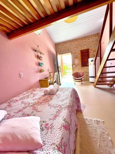 a bedroom with a bed in a room at Loft Rosa - Pousada Vila Dondom in Luis Correia