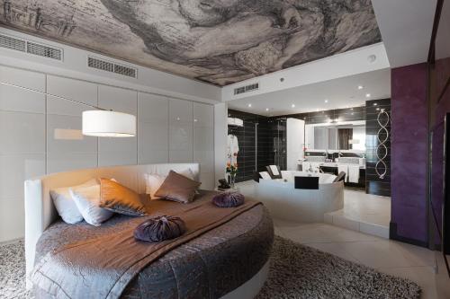 a bedroom with a large bed and a living room at Mirotel Resort and Spa in Truskavets