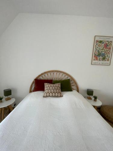 a bedroom with a large white bed with two tables at Une jolie vue - Appt 2 pièces - Vue mer Balcon sud - 150m de la plage in Wimereux