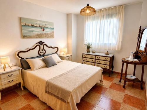 a bedroom with a bed and a painting on the wall at El Refugio de Leyla in Masía de Correntilla