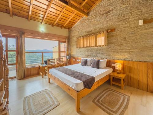 a bedroom with a bed and a brick wall at Silent Stone Homestay in Almora