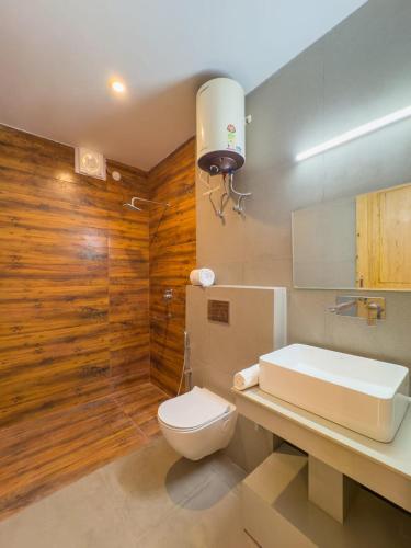 a bathroom with a toilet and a sink at Silent Stone Homestay in Almora