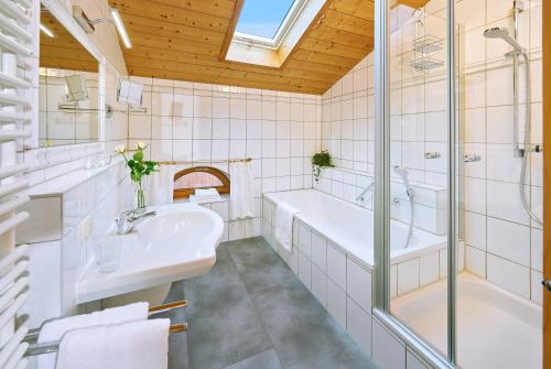 a bathroom with a tub and a sink and a shower at Köllhof in Höslwang