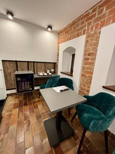 a room with chairs and a table and a tv at Hotel&Restauracja Zamek Bytów in Bytów