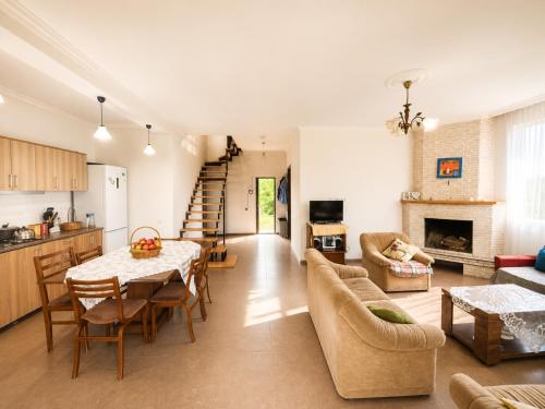 a kitchen and living room with a table and chairs at Kibula Horizon in Ureki