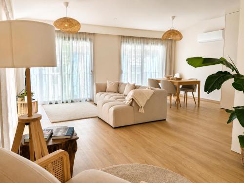 a living room with a couch and a table at Terra Clara Studios & Apartments in Esposende