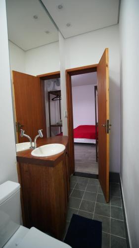 a bathroom with a sink and a toilet and a mirror at Casa do Sol in Diamantina