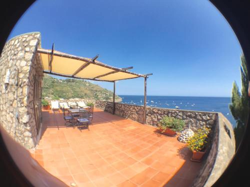 a view of a patio with the ocean in the background at Villaggio Residence Nettuno in Massa Lubrense