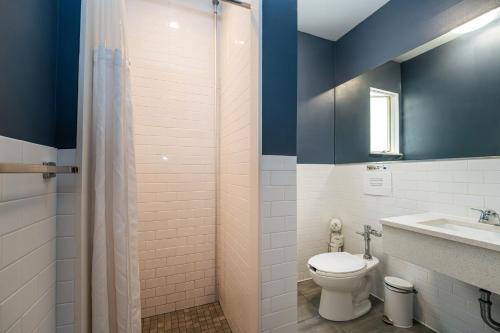 a bathroom with a toilet and a sink at Lamartine Chelsea in New York