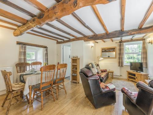 a living room with a table and chairs at Primrose Cottage - Ukc6679 in Bettws-yn-Rhôs