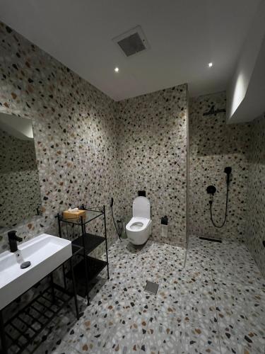 a bathroom with a toilet and a sink and a shower at Eight House villa in Jeddah