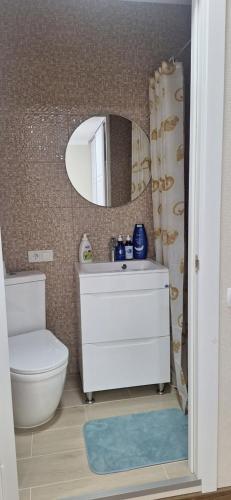 a bathroom with a sink and a toilet and a mirror at Poduszka mini-hotel in Stantsiya Rokitno Volynskoye