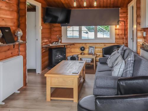 a living room with a couch and a table at Barken in Trawsfynydd