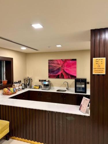 a kitchen with a counter with a sink and a microwave at Mdmak Suites in Riyadh