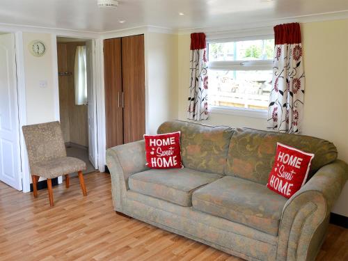 a living room with a couch and a window at Ardea - Uk12695 in Stalham