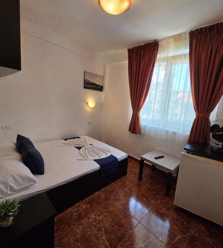 a hotel room with a bed and a window at Sea View Smart Choice in Costinesti