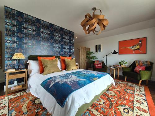 a bedroom with a large bed with a blue wall at Abhaig Boutique B&B - Small & luxurious in a great location! in Uig