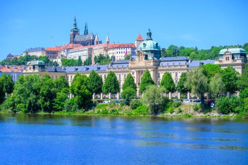 a view of a city from the river at Golden Prague Rooms in Prague