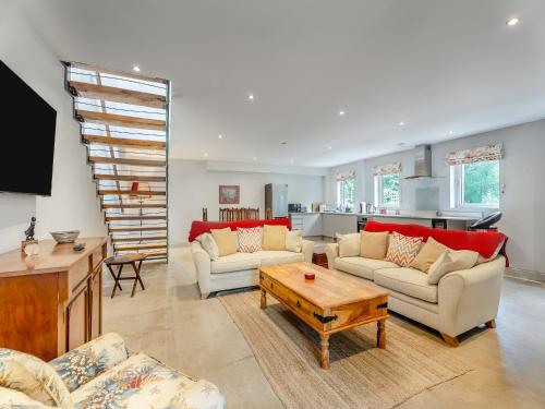 a living room with two couches and a table at Ash Hill - Uk36199 in Fordingbridge