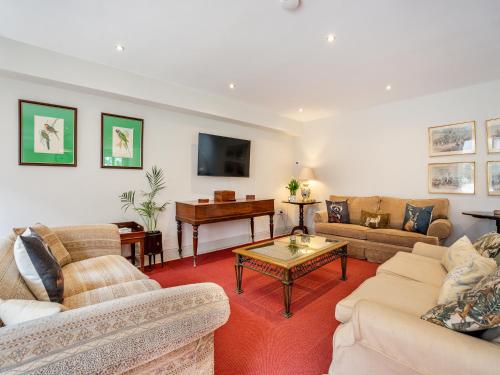 a living room with two couches and a piano at Homewood - Uk36205 in Fordingbridge