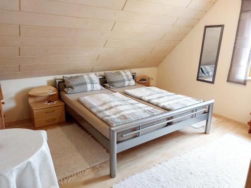 a bedroom with a large bed in a attic at Ferienwohnung Forster in Moosbach