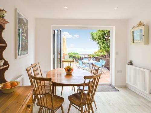 a kitchen and dining room with a table and chairs at Jan Dee Cottage in Ventnor
