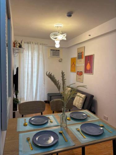 a table with plates on it in a living room at Arezzo Place in Davao City
