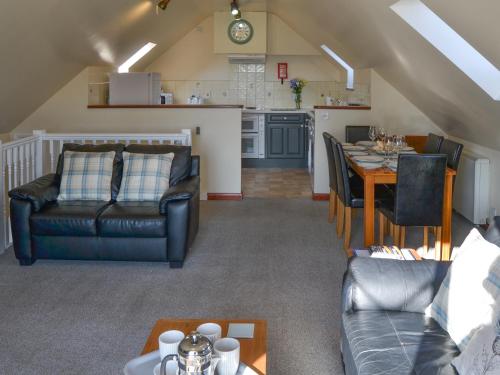 a living room with a dining table and a kitchen at Solace - Ukc2122 in Stalham