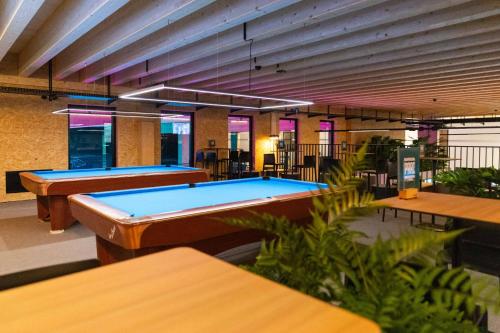 a row of ping pong tables in a room at Auberge du Parc in Delémont