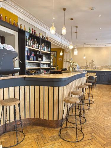 a bar in a restaurant with stools at Europe Hôtel in Castres