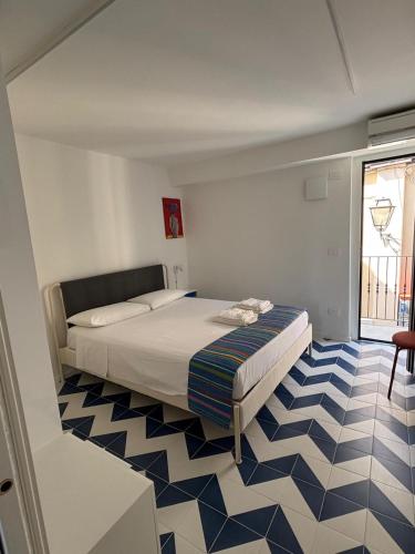 a bedroom with a bed and a blue and white floor at Bordo piazza in Vasto